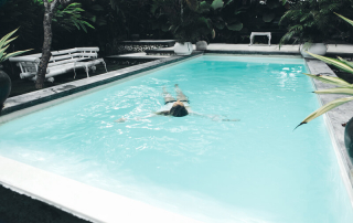 beautiful-young-woman-at-swimming-pool-PV6L6Y9-800x533